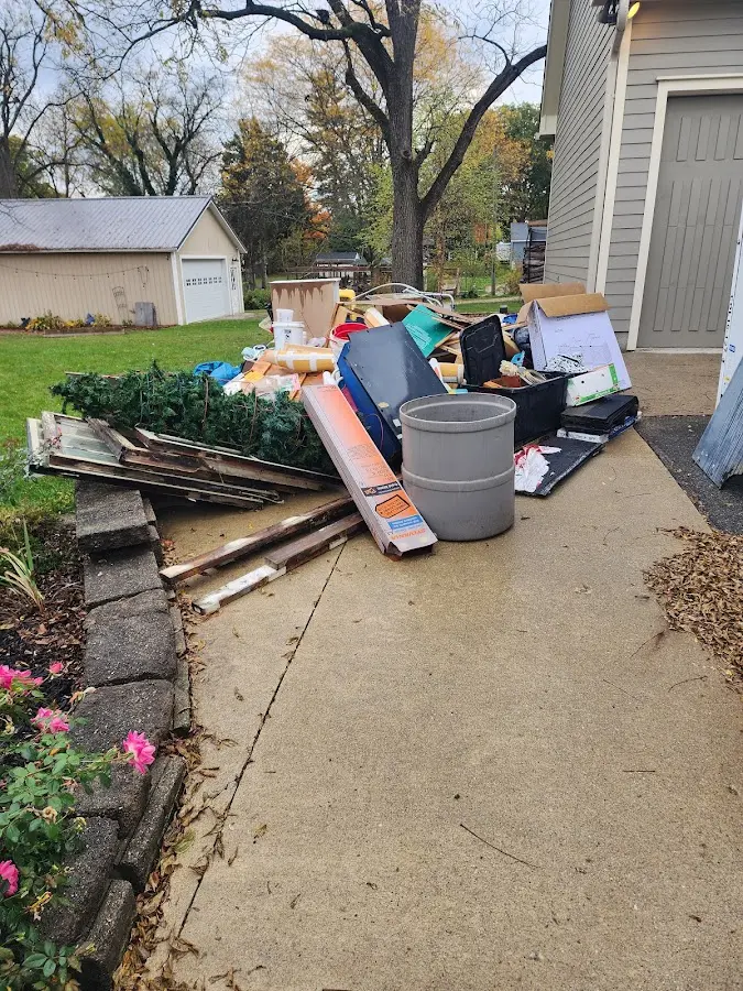 Dumpster being loaded with debris for 3 Yard Dumpster Rental in Cottage Grove